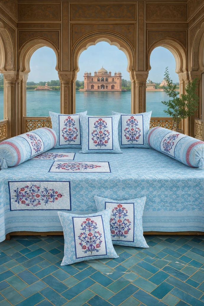 View our Premium 8-Piece Diwan Set Collection - Pure Jaipur Cotton. Blue and white floral print diwan set with bolster and cushion covers in a Rajasthani palace setting.